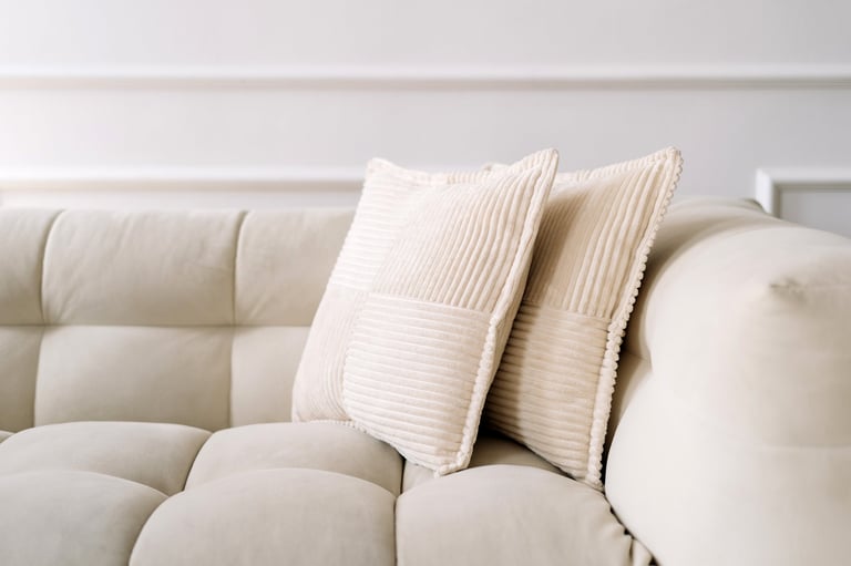 Cushions on sofa with soft pillows in room, showcasing modern interior design