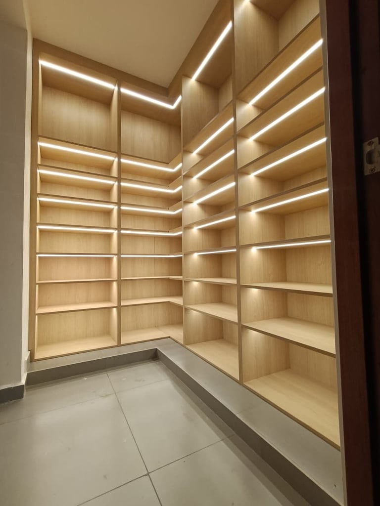 Empty wooden shelving unit with LED lighting in a modern corner display or storage space with tile flooring